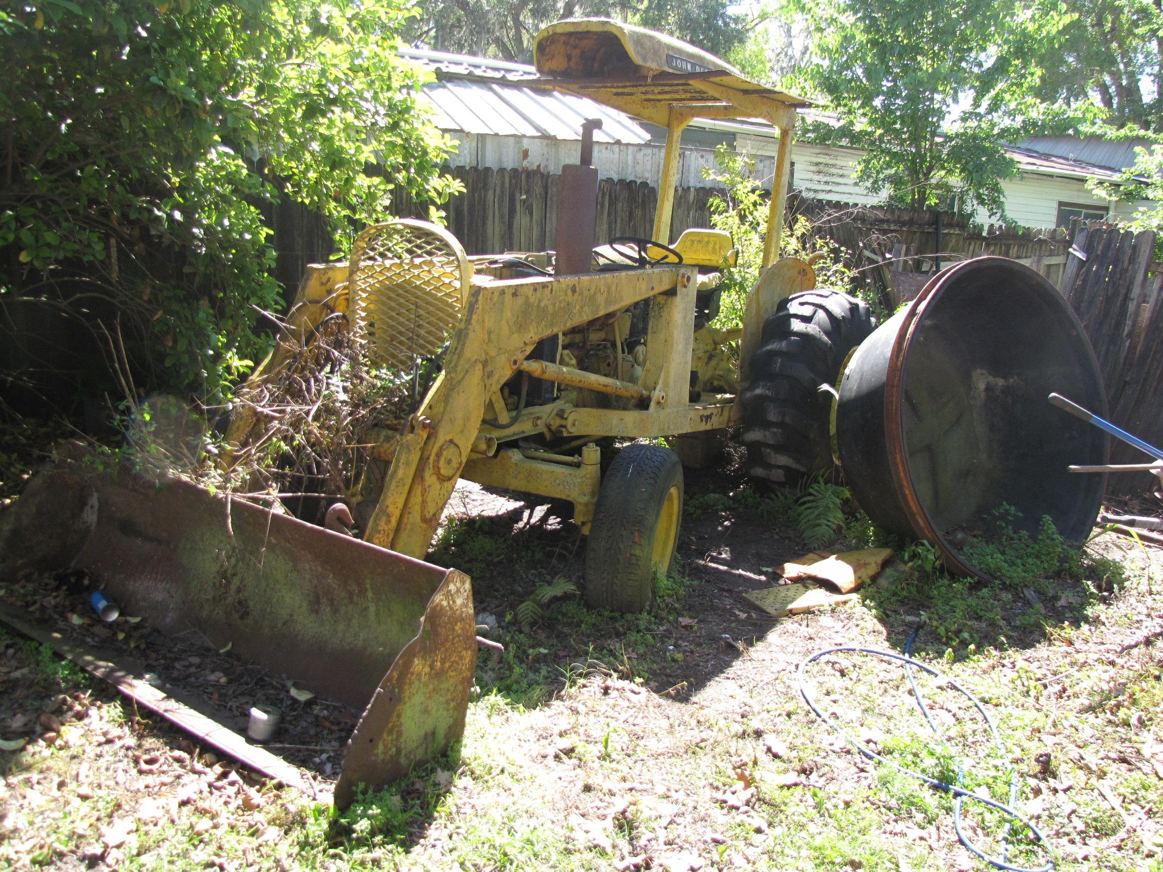 Before restoration photo of John Deere 301A diesel tractor with loader